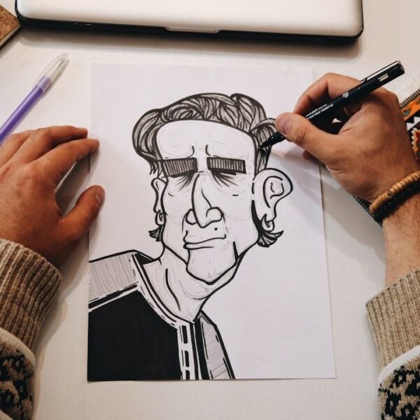 Artiste dessinant à l’encre un personnage de bande dessinée sur papier